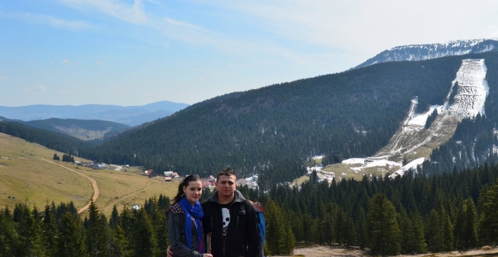 Valentin and his wife Ottilia on a hike. There are mountains and tees in the background